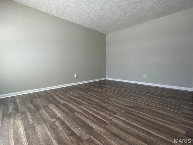 6023 Shillington Dr, Berkeley, MO 63134 - unfurnished room with dark wood-style flooring and a textured ceiling
