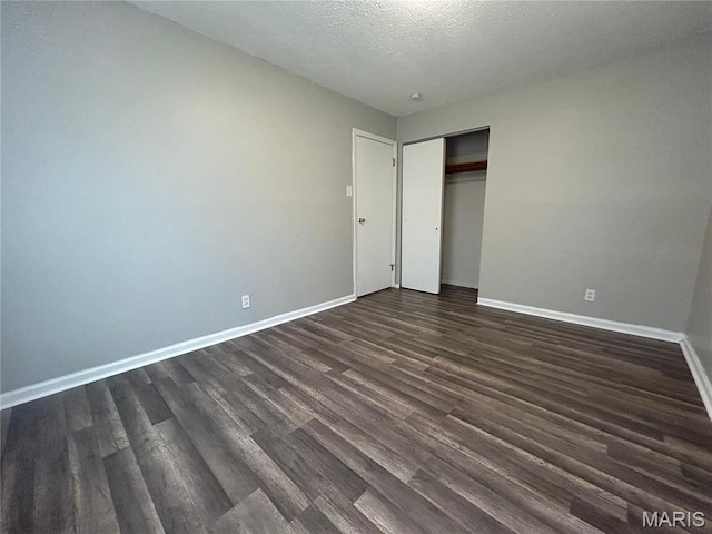 6023 Shillington Dr, Berkeley, MO 63134 - unfurnished bedroom featuring dark wood finished floors, a closet, and a textured ceiling