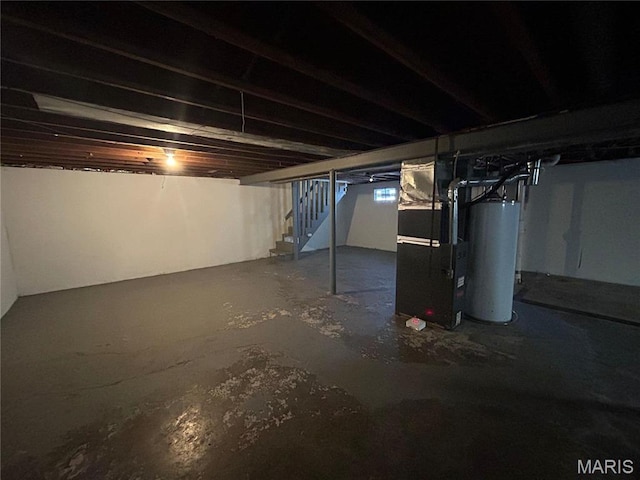 6023 Shillington Dr, Berkeley, MO 63134 - unfinished below grade area with water heater, stairway, and heating unit