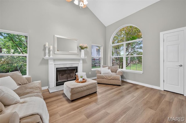 794 Buckboard Ln, Fenton, MO 63026 - living room featuring high vaulted ceiling, healthy amount of natural light, a high end fireplace, a ceiling fan, and light wood-style floors