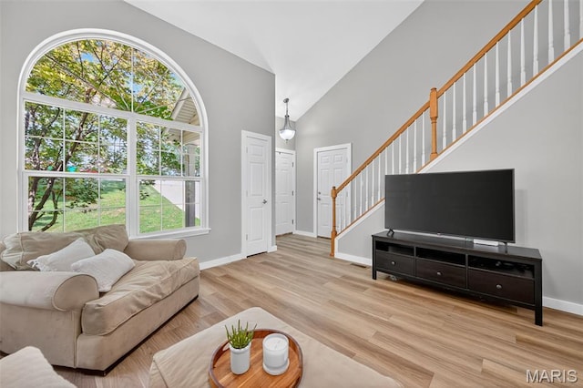 794 Buckboard Ln, Fenton, MO 63026 - living room featuring stairway, wood finished floors, and high vaulted ceiling