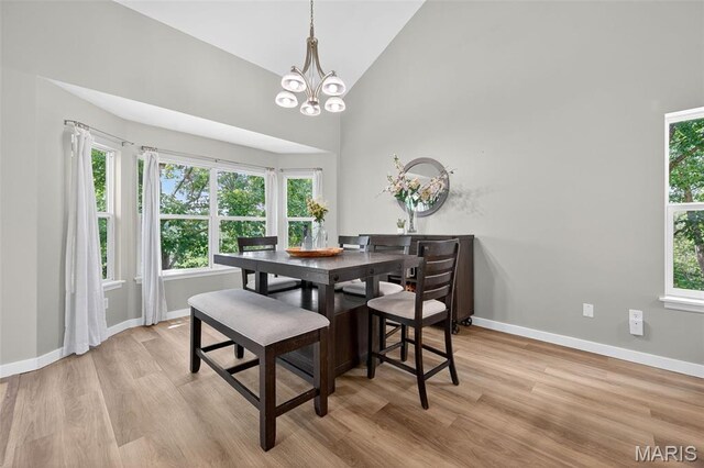 794 Buckboard Ln, Fenton, MO 63026 - dining room with light wood-type flooring, a chandelier, and high vaulted ceiling