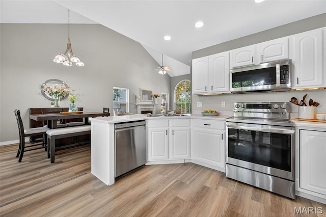 794 Buckboard Ln, Fenton, MO 63026 - kitchen featuring stainless steel appliances, a peninsula, recessed lighting, white cabinetry, and light wood-style floors