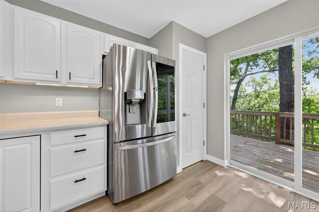 794 Buckboard Ln, Fenton, MO 63026 - kitchen featuring stainless steel fridge, light wood-style floors, light countertops, and white cabinetry