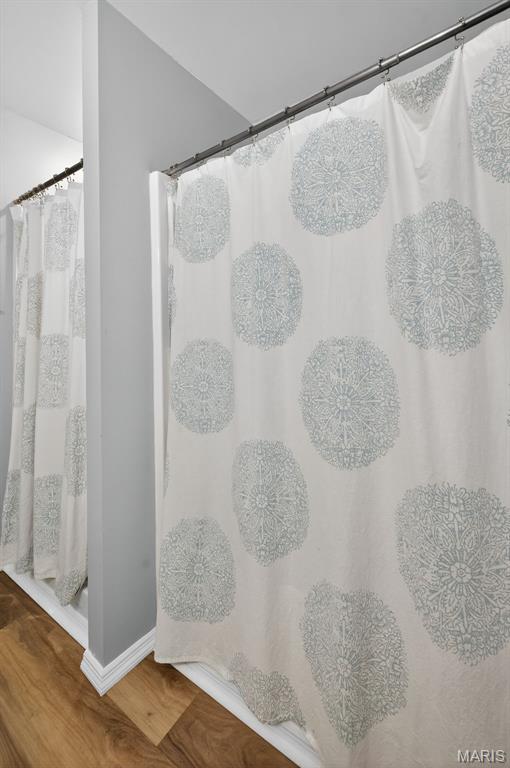 794 Buckboard Ln, Fenton, MO 63026 - full bath featuring wood finished floors and a shower with shower curtain