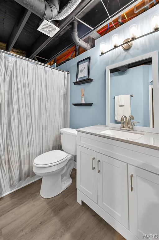 794 Buckboard Ln, Fenton, MO 63026 - bathroom with vanity, wood finished floors, and curtained shower