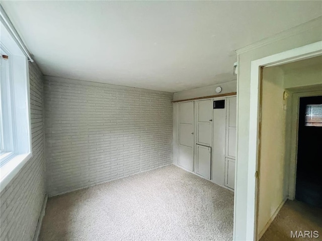 628 Valley View Dr, Bethalto, IL 62010 - unfurnished bedroom featuring brick wall, carpet flooring, and a closet