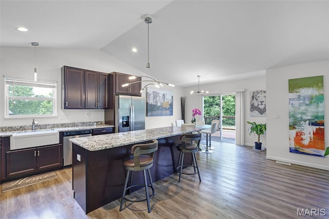 1007 Crows Nest Ct, Caseyville, IL 62232 - kitchen featuring appliances with stainless steel finishes, wood finished floors, lofted ceiling, dark brown cabinets, and a kitchen bar