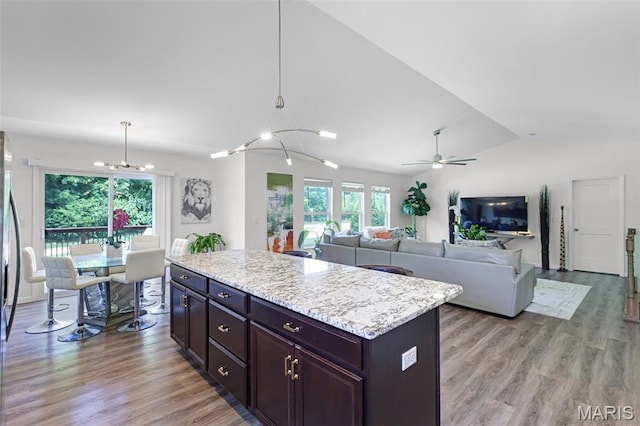 1007 Crows Nest Ct, Caseyville, IL 62232 - kitchen featuring lofted ceiling, a chandelier, light wood-style flooring, a ceiling fan, and a center island