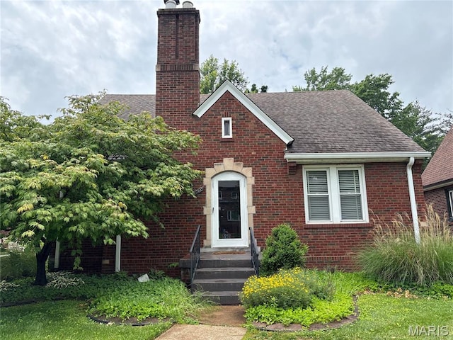 8260 Glen Echo Dr, Bel-Nor, MO 63121 - view of front of property with brick siding, a chimney, and roof with shingles