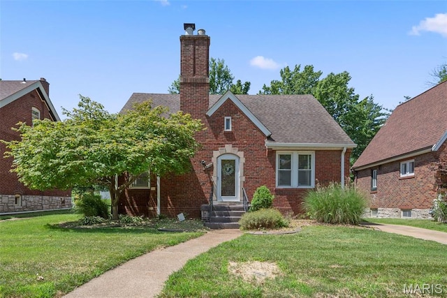 8260 Glen Echo Dr, Bel-Nor, MO 63121 - tudor house featuring a chimney, a front yard, brick siding, and a shingled roof