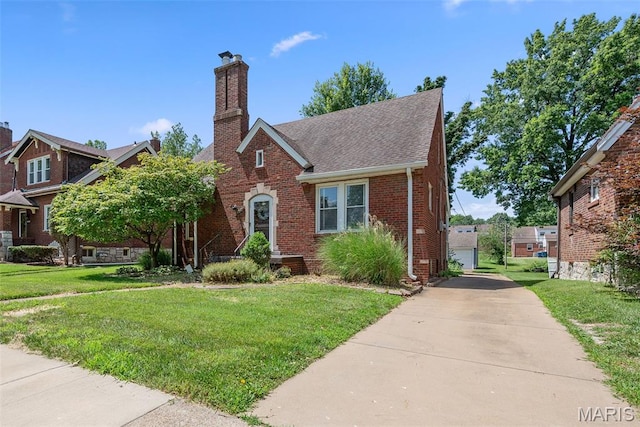 8260 Glen Echo Dr, Bel-Nor, MO 63121 - english style home featuring brick siding, a front yard, a chimney, and a shingled roof