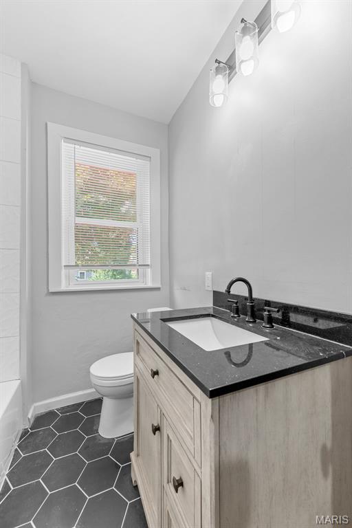 8260 Glen Echo Dr, Bel-Nor, MO 63121 - full bath with vanity and tile patterned floors