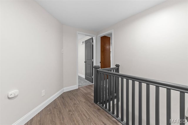 8260 Glen Echo Dr, Bel-Nor, MO 63121 - hallway featuring wood finished floors and an upstairs landing