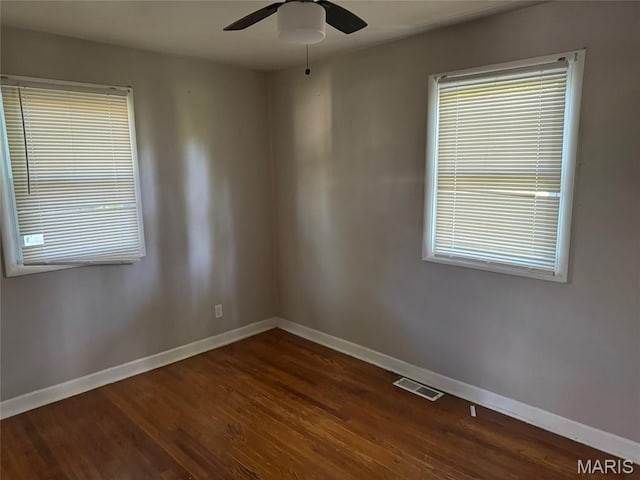 11880 Criterion Ave, Saint Louis, MO 63138 - spare room with dark wood-type flooring, a ceiling fan, and plenty of natural light