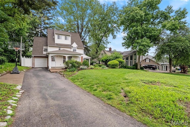 1931 Elm St, Saint Charles, MO 63301 - view of front of property featuring asphalt driveway, a garage, a front yard, and a shingled roof