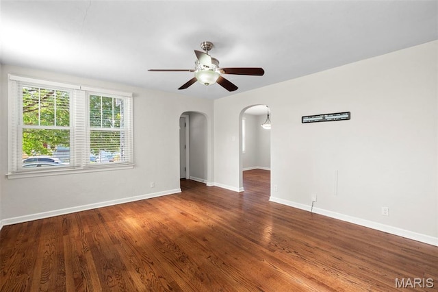 6915 Wise Ave, Saint Louis, MO 63139 - spare room with arched walkways, ceiling fan, and wood finished floors