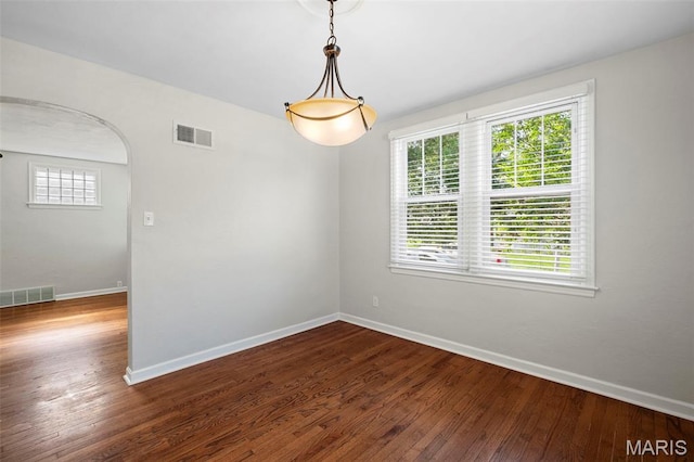 6915 Wise Ave, Saint Louis, MO 63139 - spare room featuring baseboards and dark wood-style flooring