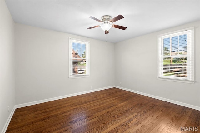 6915 Wise Ave, Saint Louis, MO 63139 - empty room with plenty of natural light, dark wood-type flooring, and a ceiling fan