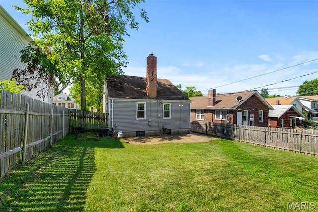 6915 Wise Ave, Saint Louis, MO 63139 - back of house featuring a chimney, a patio, and a fenced backyard