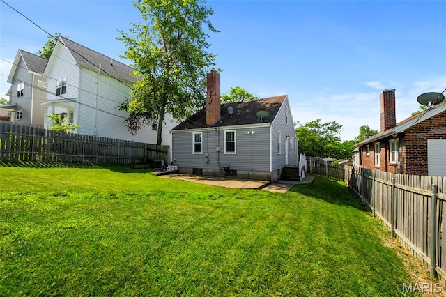 6915 Wise Ave, Saint Louis, MO 63139 - rear view of property featuring a fenced backyard, a patio, and entry steps