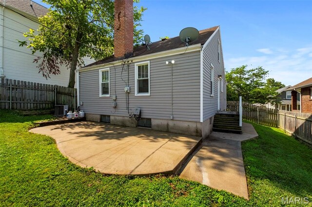 6915 Wise Ave, Saint Louis, MO 63139 - rear view of property featuring a chimney, a patio, and a fenced backyard