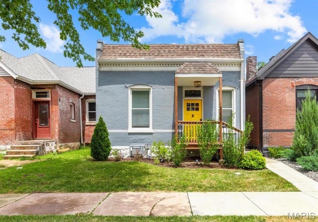 4355 Hunt Ave, Saint Louis, MO 63110 - view of front of property with brick siding, a front yard, and a shingled roof