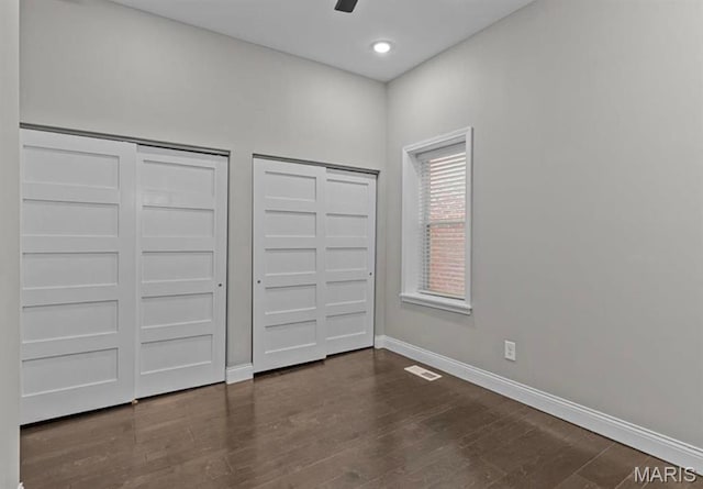 4355 Hunt Ave, Saint Louis, MO 63110 - unfurnished bedroom featuring multiple closets, dark wood-type flooring, ceiling fan, and recessed lighting