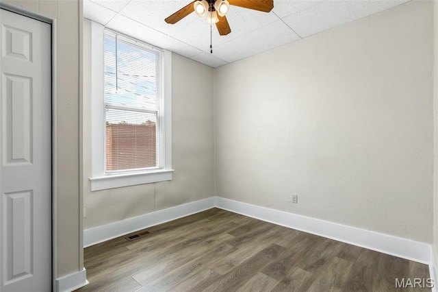 229 Broadway Ave, Crystal City, MO 63019 - empty room featuring dark wood-type flooring, ceiling fan, and a drop ceiling