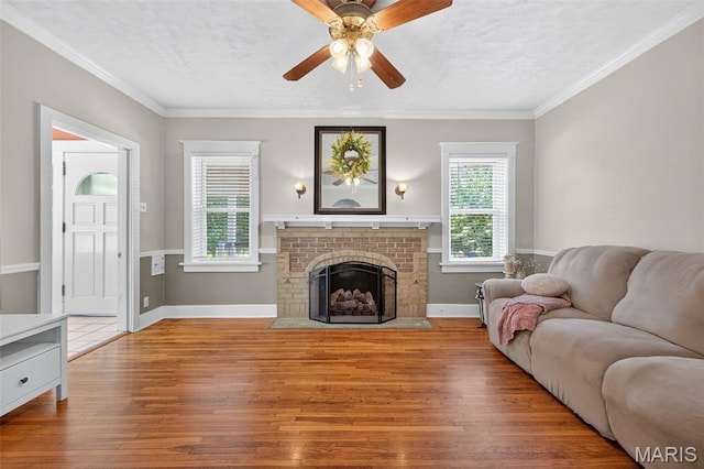 5965 S Cuba Ct, Saint Louis, MO 63139 - living area with hardwood / wood-style flooring, ceiling fan, a brick fireplace, and crown molding