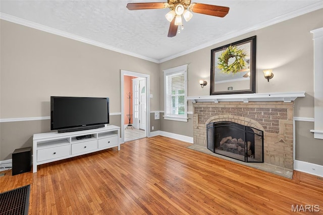 5965 S Cuba Ct, Saint Louis, MO 63139 - unfurnished living room with hardwood / wood-style flooring, a ceiling fan, a fireplace, and ornamental molding