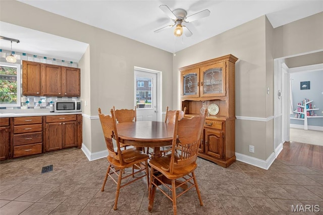 5965 S Cuba Ct, Saint Louis, MO 63139 - tiled dining space with ceiling fan and baseboards