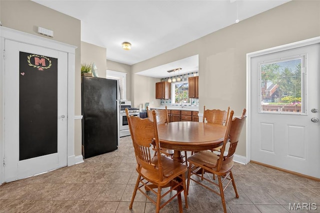 5965 S Cuba Ct, Saint Louis, MO 63139 - dining space featuring light tile patterned floors and plenty of natural light