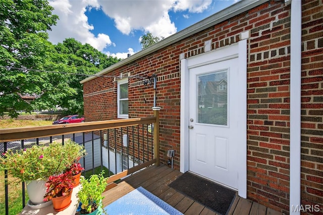 5965 S Cuba Ct, Saint Louis, MO 63139 - doorway to property with brick siding and a wooden deck