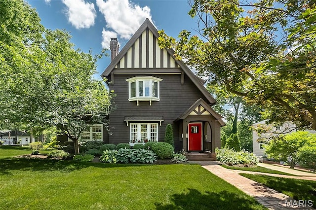 444 Algonquin Pl, Webster Groves, MO 63119 - english style home featuring a chimney and a front lawn