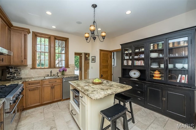 444 Algonquin Pl, Webster Groves, MO 63119 - kitchen with appliances with stainless steel finishes, stone tile flooring, recessed lighting, tasteful backsplash, and brown cabinetry
