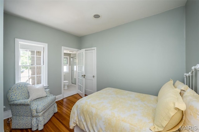 444 Algonquin Pl, Webster Groves, MO 63119 - bedroom with wood finished floors and connected bathroom