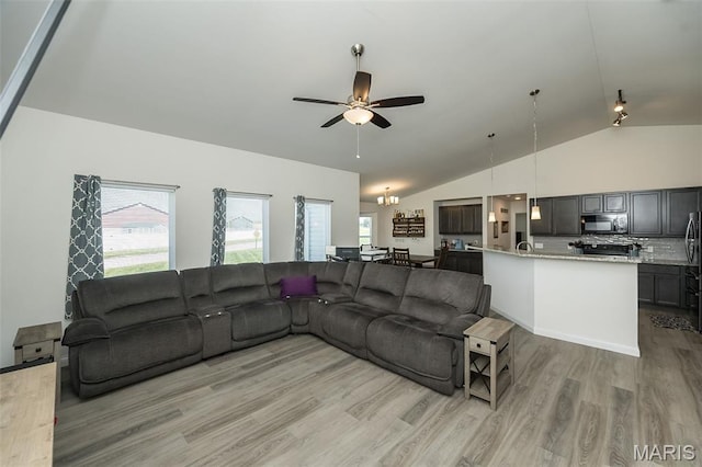 229 Essex Ct, Wright City, MO 63390 - living room featuring vaulted ceiling, light wood-type flooring, a ceiling fan, and a chandelier