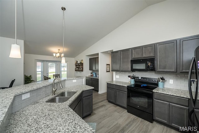 229 Essex Ct, Wright City, MO 63390 - kitchen with black appliances, a chandelier, light wood-style flooring, decorative backsplash, and light stone counters