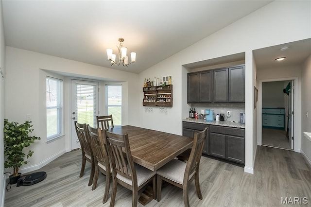229 Essex Ct, Wright City, MO 63390 - dining room featuring a chandelier, light wood-style floors, and vaulted ceiling