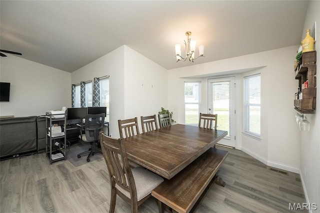229 Essex Ct, Wright City, MO 63390 - dining space with a chandelier, wood finished floors, healthy amount of natural light, and vaulted ceiling