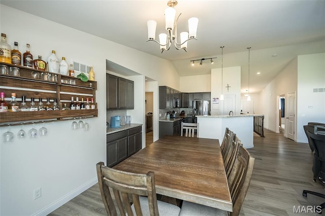 229 Essex Ct, Wright City, MO 63390 - dining area featuring lofted ceiling, a chandelier, and wood finished floors