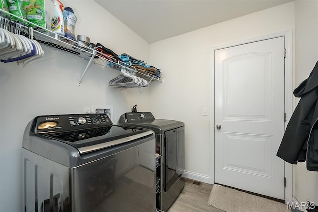 229 Essex Ct, Wright City, MO 63390 - laundry area with washing machine and dryer and light wood-style flooring