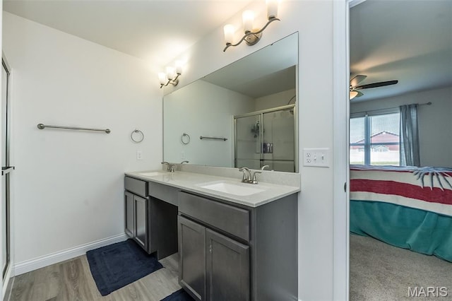 229 Essex Ct, Wright City, MO 63390 - ensuite bathroom featuring double vanity, a shower with shower door, a ceiling fan, and wood finished floors
