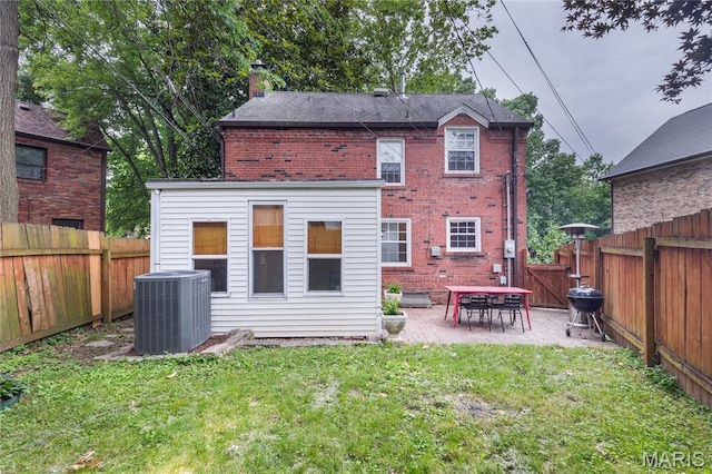 1076 N Jackson Ave, University City, MO 63130 - back of property featuring brick siding, a chimney, a patio, and a fenced backyard