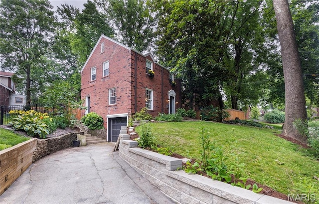 1076 N Jackson Ave, University City, MO 63130 - view of side of property featuring asphalt driveway, an attached garage, and brick siding