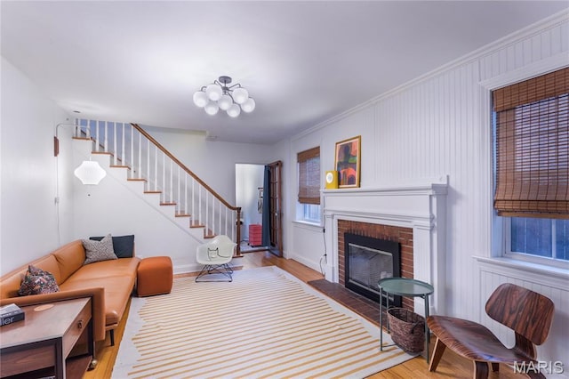 1076 N Jackson Ave, University City, MO 63130 - living room with wood finished floors, a fireplace, and stairway