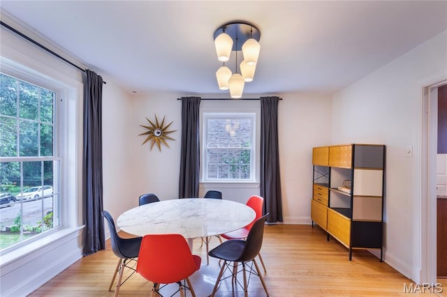 1076 N Jackson Ave, University City, MO 63130 - dining area featuring healthy amount of natural light and light wood finished floors