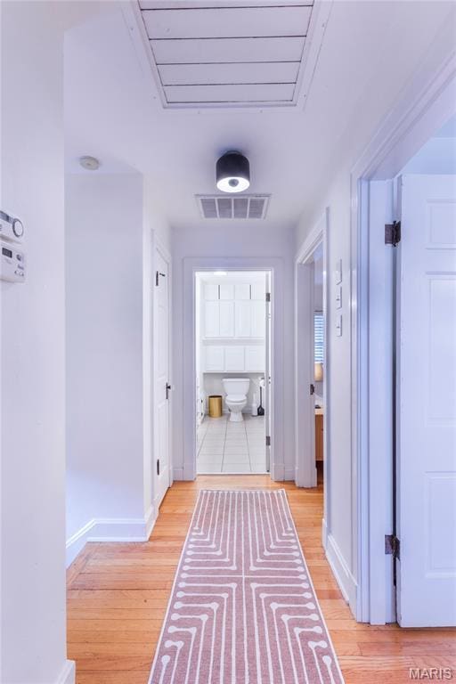 1076 N Jackson Ave, University City, MO 63130 - hallway featuring light wood-type flooring and baseboards
