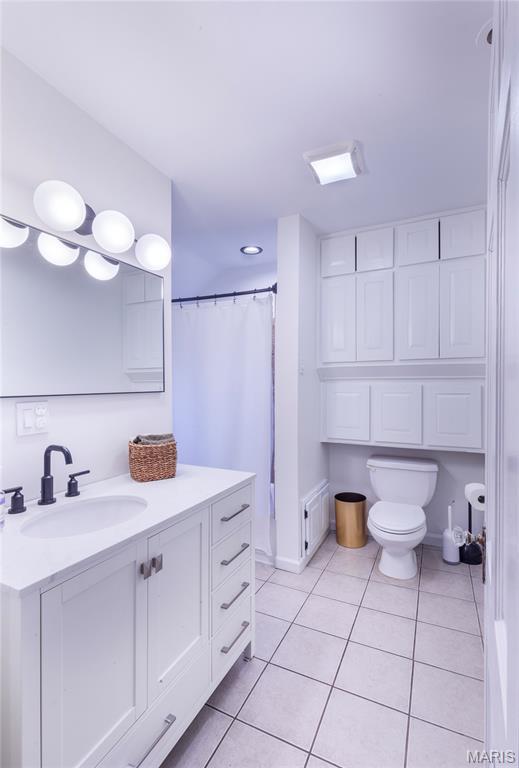 1076 N Jackson Ave, University City, MO 63130 - bathroom featuring tile patterned flooring and vanity